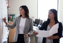 Two teachers working at a whiteboard