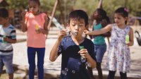 Children blowing bubbles