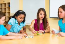 Elementary students playing a card game