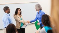 Teacher greeting classroom guests