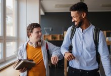 Teacher and student giving each other an elbow bump