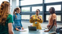 High school teacher talking to 3 students