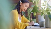 Woman writing in a journal