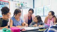 Teacher working with students in the classroom