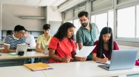 Teacher going over paper with student