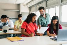 Teacher going over paper with student