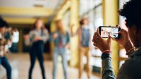 Students filming each other with a smartphone