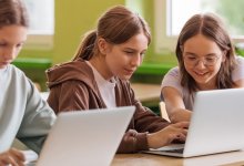 Students working at laptops together