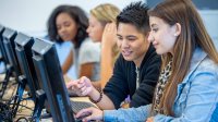 High school students working on computers together