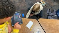 Two students working on a stop-motion video project