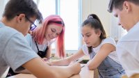 Four high school students working together in class