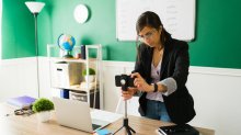 Photo of teacher setting up a phone to record her lecture in classroom