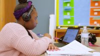 High school student completing an instructional video at her desk