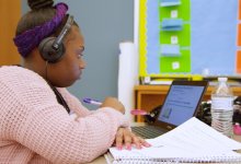 High school student completing an instructional video at her desk