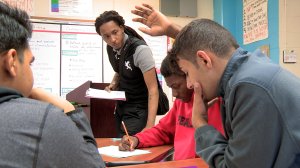 Teacher helping students in classroom at Pearl Cohn High School.