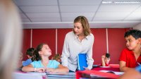 Photo of elementary school teacher with students in classroom