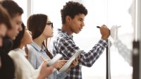 High school students work together at whiteboard