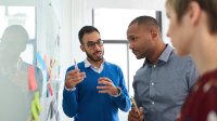 Teachers talking at white board