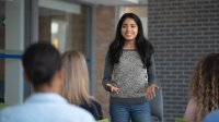 High school student standing at the front of her class and giving a presentation