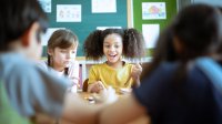 Elementary students playing a game together at their desks