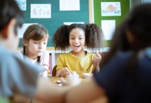 Elementary students playing a game together at their desks