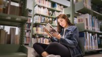 Photo of high school student reading book.