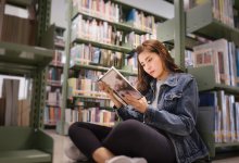 Photo of high school student reading book.