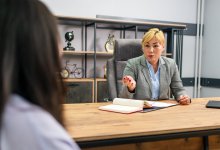 Administrator talks to student in her office