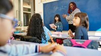 Photo of elementary school teacher and students