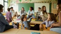 Middle school students talking in classroom