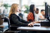 Female student in wheelchair working at computer station