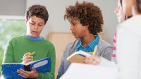 Students working together with notebooks and pencils