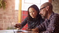 Photo of two teachers looking at computer