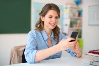 A teacher making a phone call on a cell phone