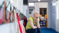 Photo of teacher sitting in hallway