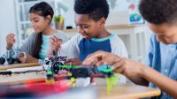 Middle school students working on robotics in class