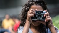 Young girl using a vintage camera to take photos