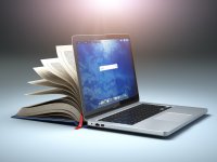 A computer and book indicating new challenges in digital learning.