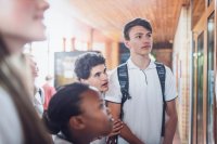 A group of middle school students looking at a bulletin board