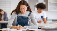 High school students writing in classroom