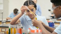 Middle school students doing a science experiment in classroom