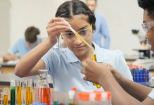 Middle school students doing a science experiment in classroom