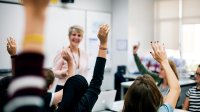 High school teacher in classroom with students