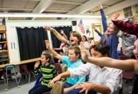 Vermont students wave to Korean students during a virtual presentation.