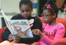 Two girls reading together