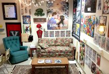 A classroom nook with a couch, armchair, and coffee table