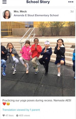 A group of elementary students are doing yoga outside during recess. 