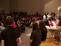 Room filled with people listening to a group at the front