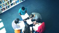 Photo of high school students reading books