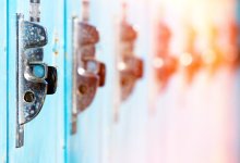 A closeup on 6 adjacent lockers. The first locker is clear and blue, each locker following gets more and more out of focus and shifts into reds and yellows, looking like a rainbow.